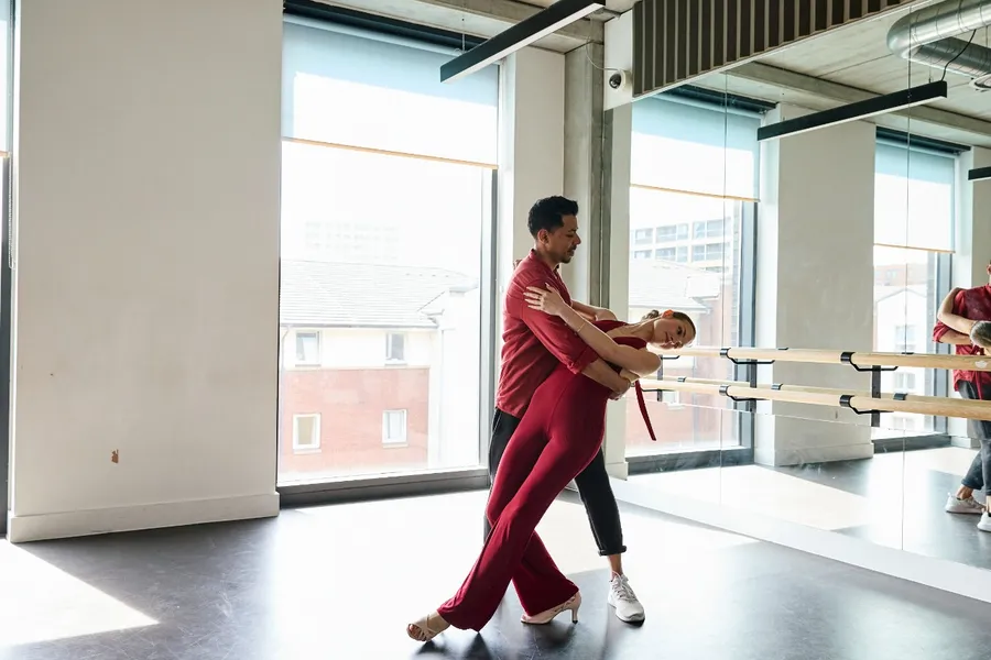 A couple performing a bachata dip