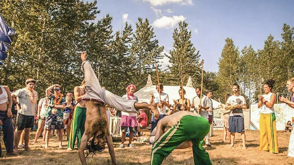 Two capoeira practitioners performing outdoors