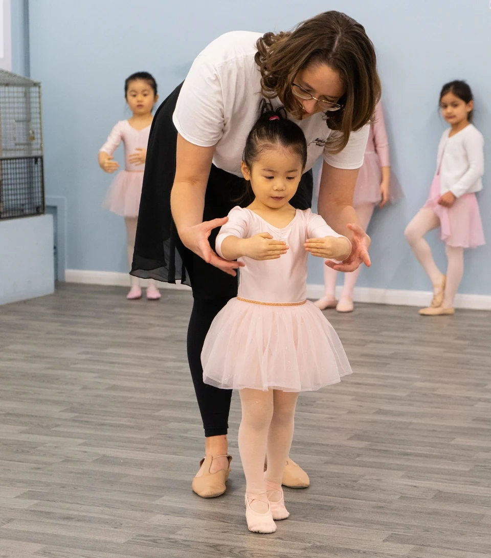 Ballet class with children and instructor in studio