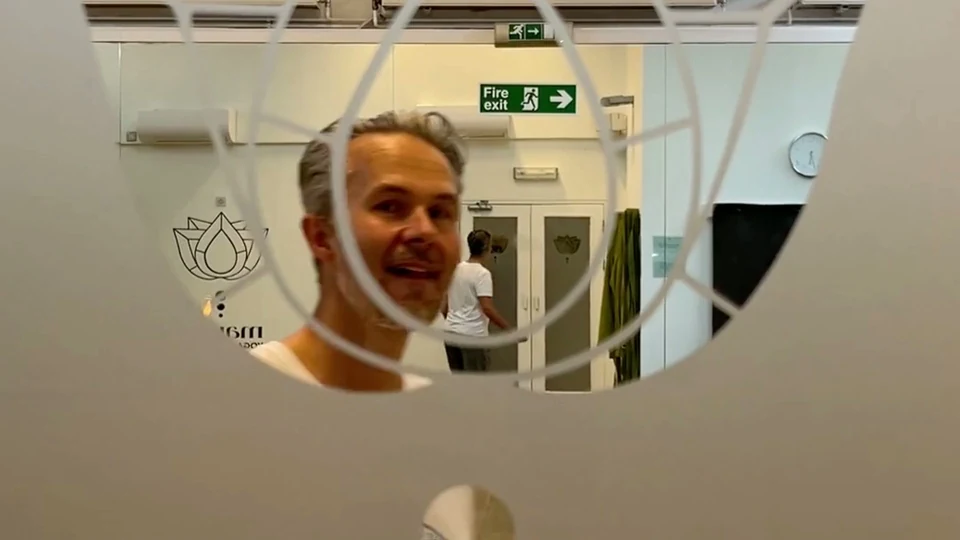 Man seen through a decorative partition in a dance studio