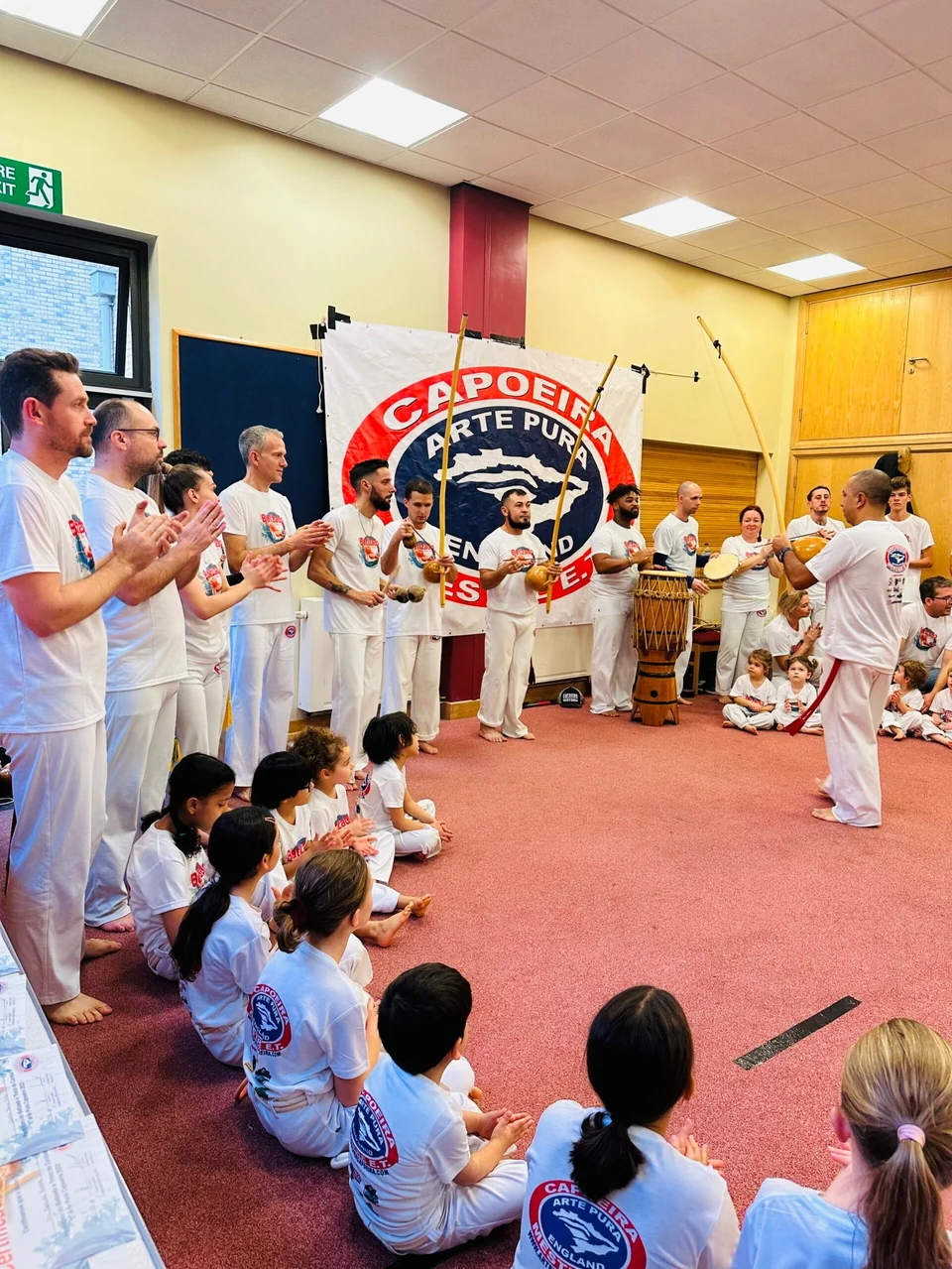 Group of people practicing Capoeira in a studio
