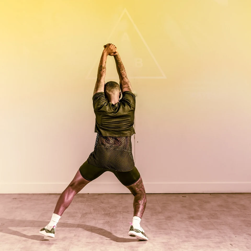 Dancer performing in a studio with yellow background