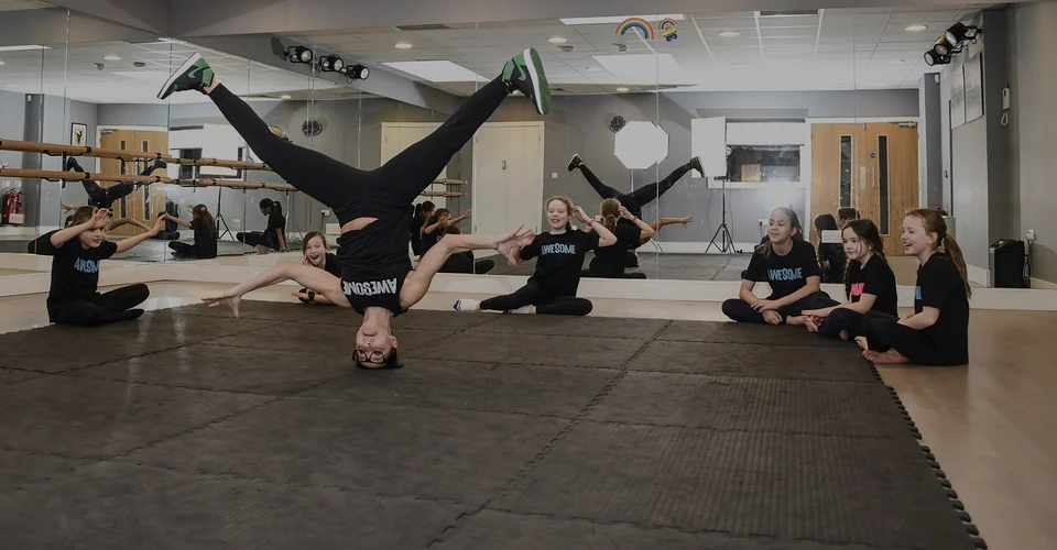 Dancer performing a handstand in a studio