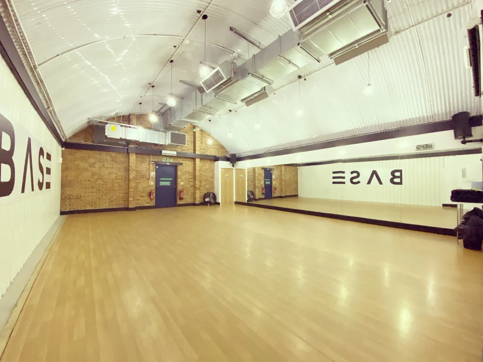Dance studio interior with wooden floor and mirrors