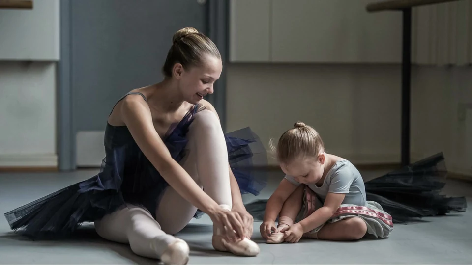 Two young dancers preparing in a studio