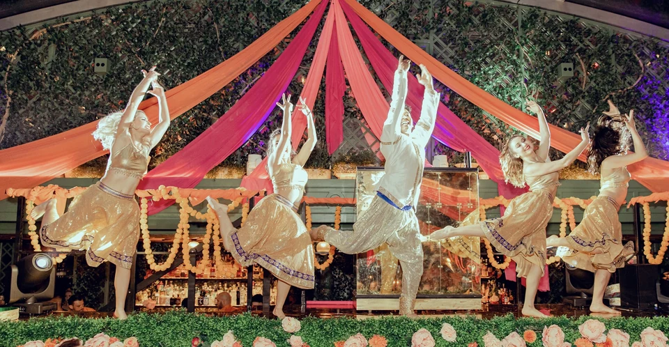 Group of dancers performing on stage with decorations