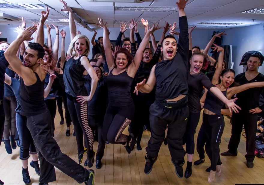 Group of dancers celebrating in a studio