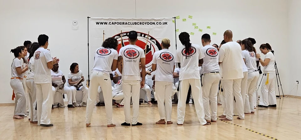 Group of people practicing Capoeira in a studio