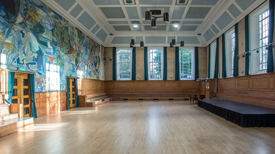 Dance hall with wooden floor and mural walls