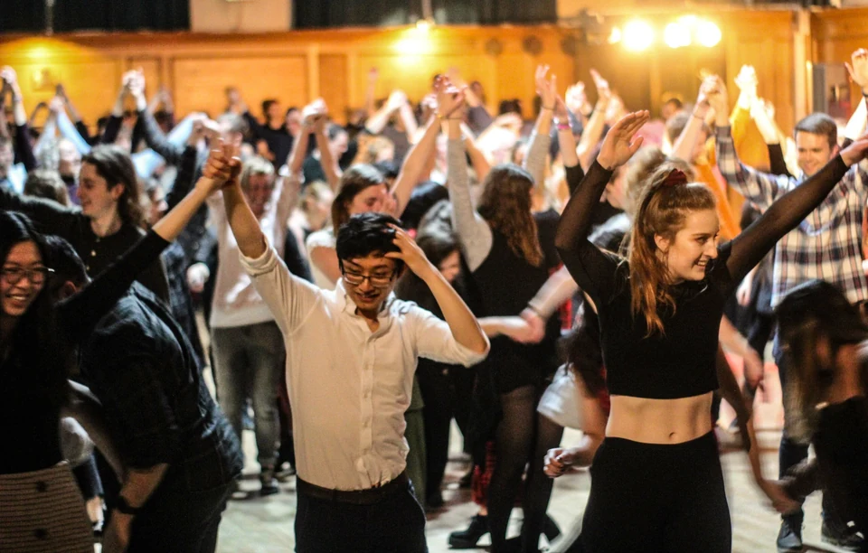 Group of people dancing in a hall