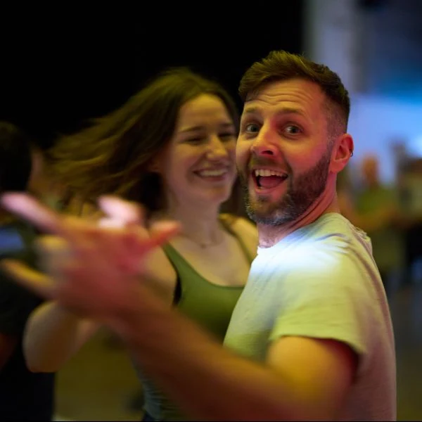 Couple dancing in a lively dance setting