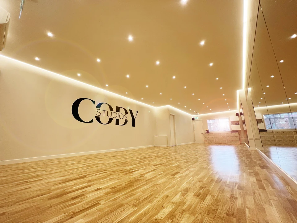 Dance studio interior with wooden floor and mirrors