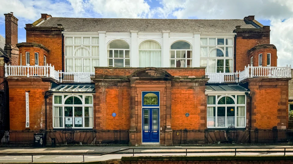 Exterior view of a brick building with large windows