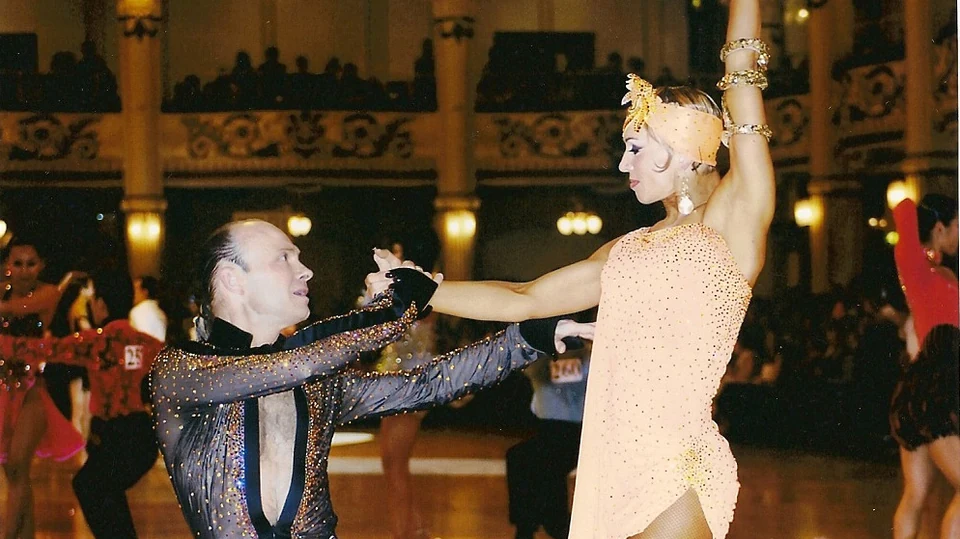 Couple dancing in a ballroom competition setting