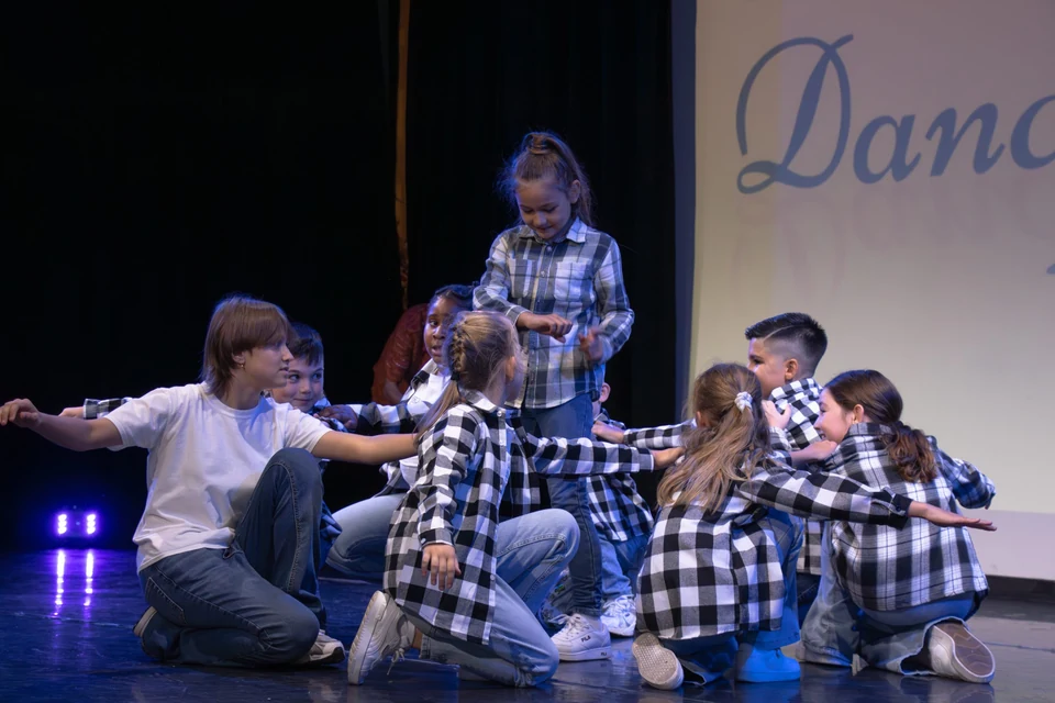 Children performing a dance routine on stage