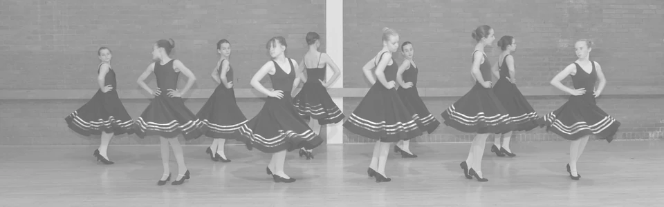 Group of dancers in black dresses performing