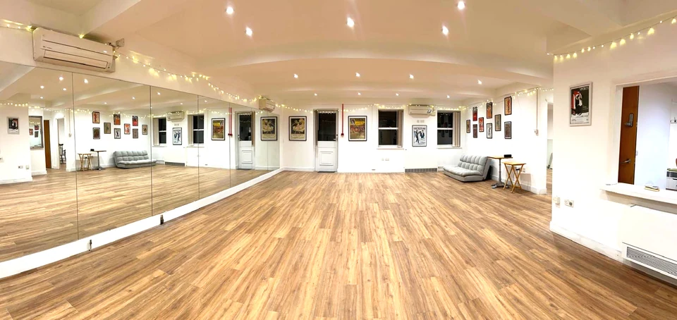 Dance studio with wooden floor and mirrors