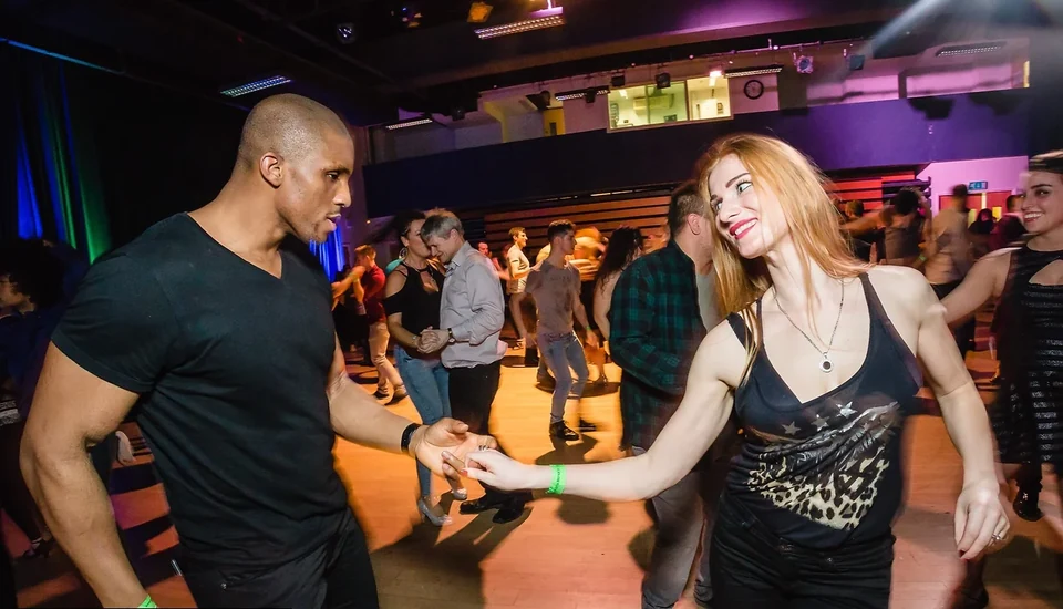 Couple dancing in a lively dance studio