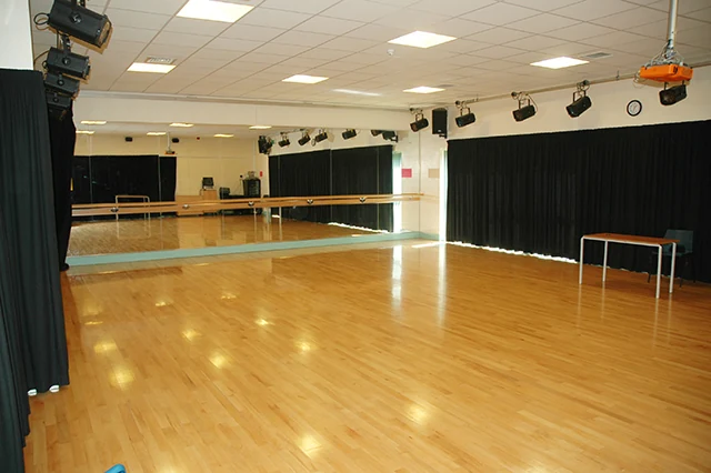 Dance studio with wooden floor and mirrors