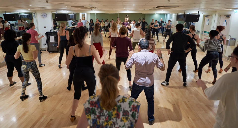 Dance class in a studio with participants dancing