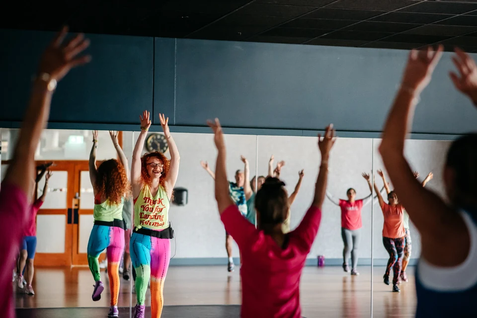 Zumba class in a dance studio with participants
