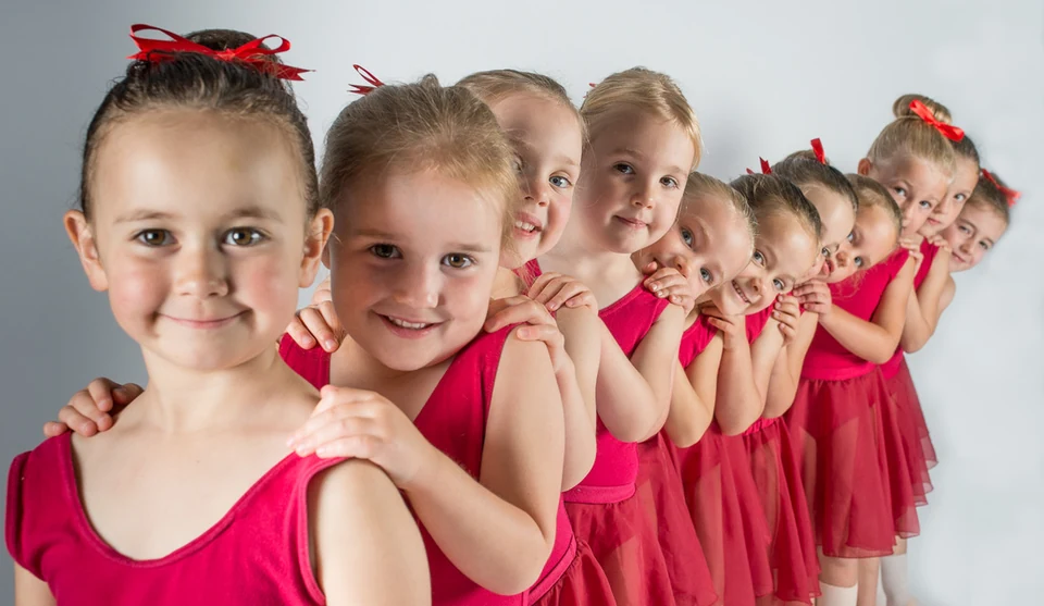 Group of young dancers in red costumes