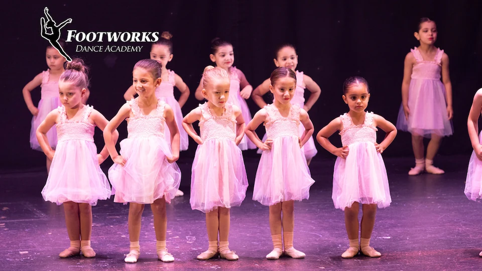 Young dancers in pink tutus on stage