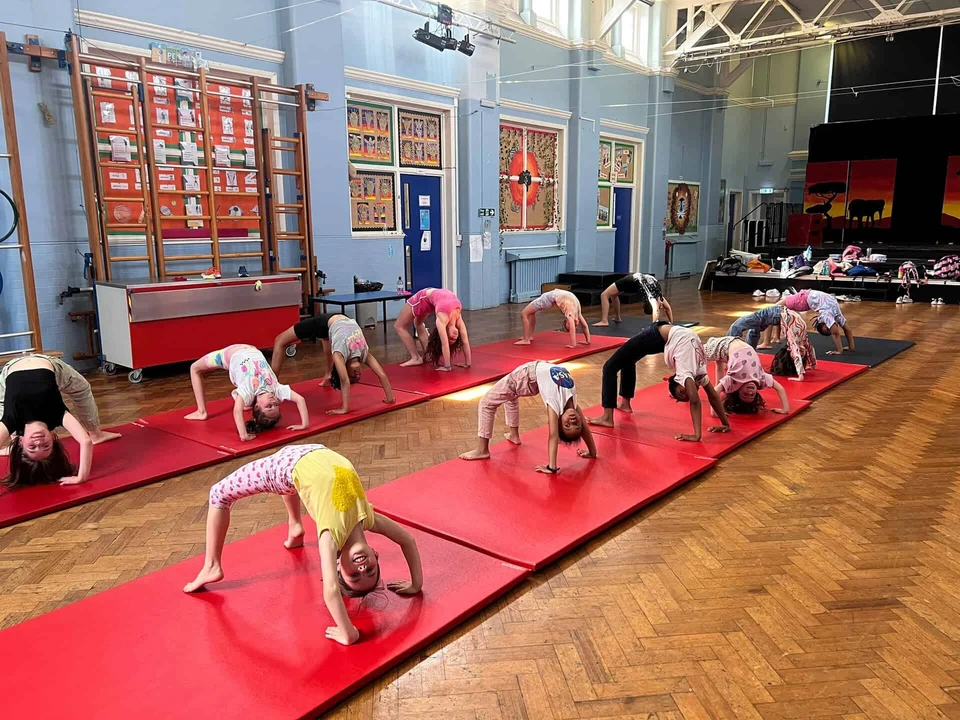 Children practicing acro dance on mats