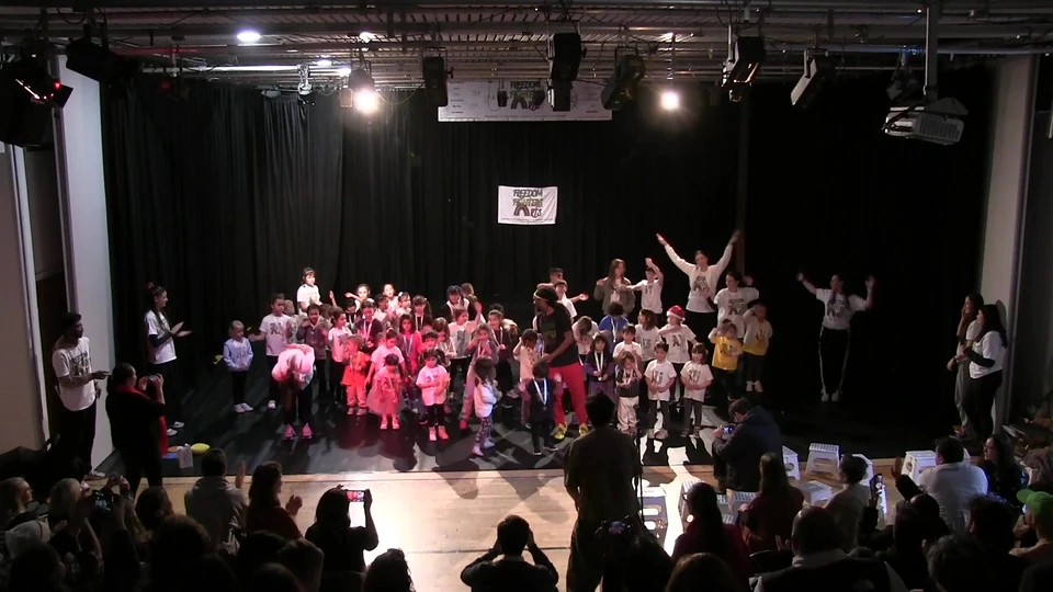 Children performing on stage at a dance event