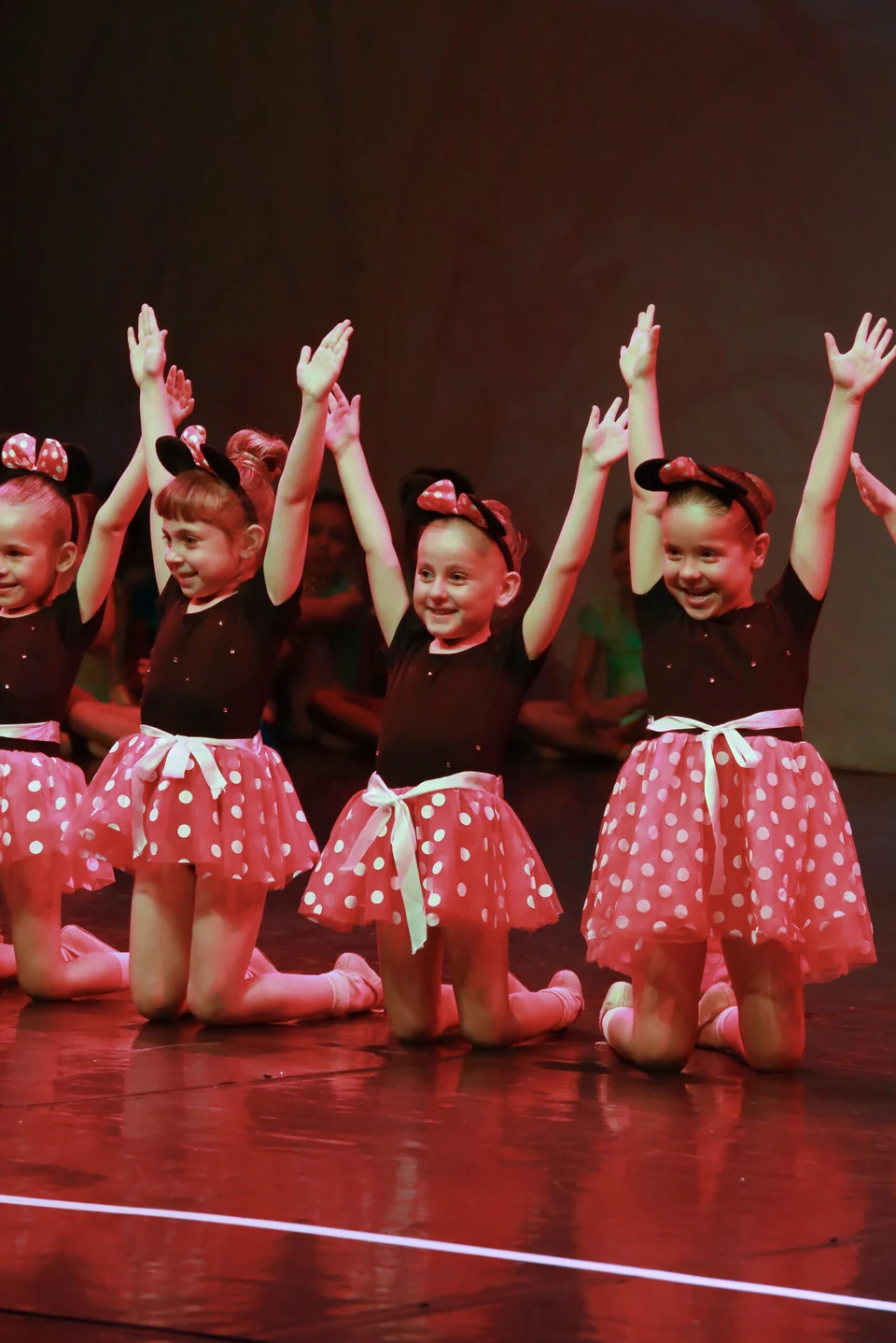 Children performing in polka dot costumes
