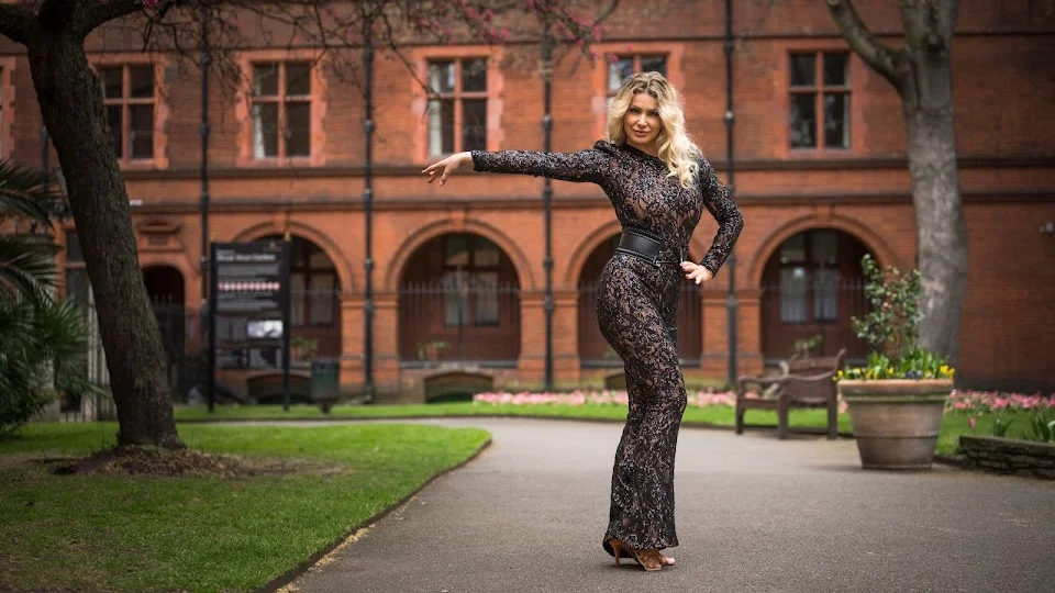 Woman in dance attire posing outdoors