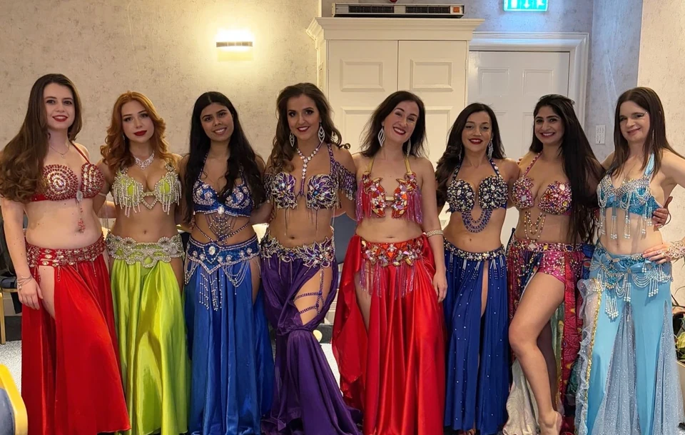 Group of women in colorful belly dance costumes