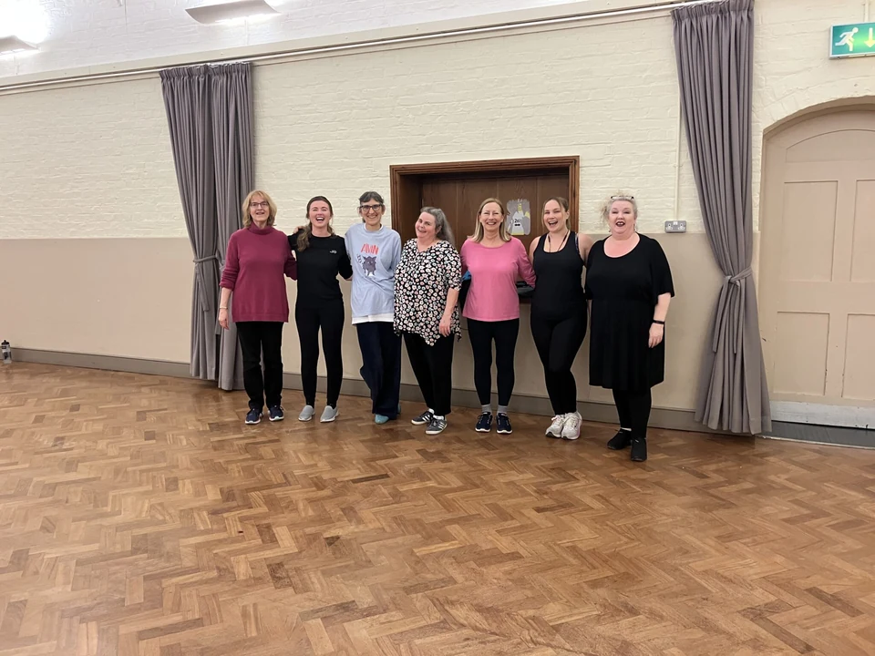 Group of women in dance attire in a studio