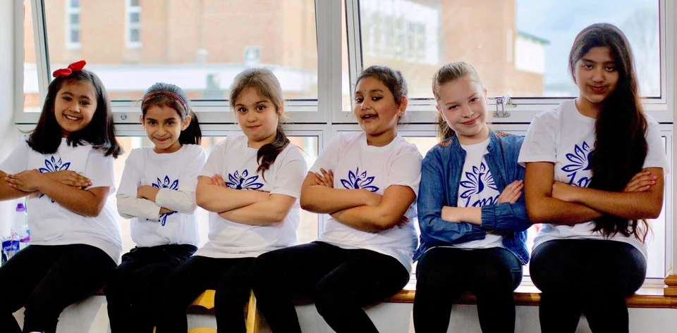 Group of girls in dance attire sitting together