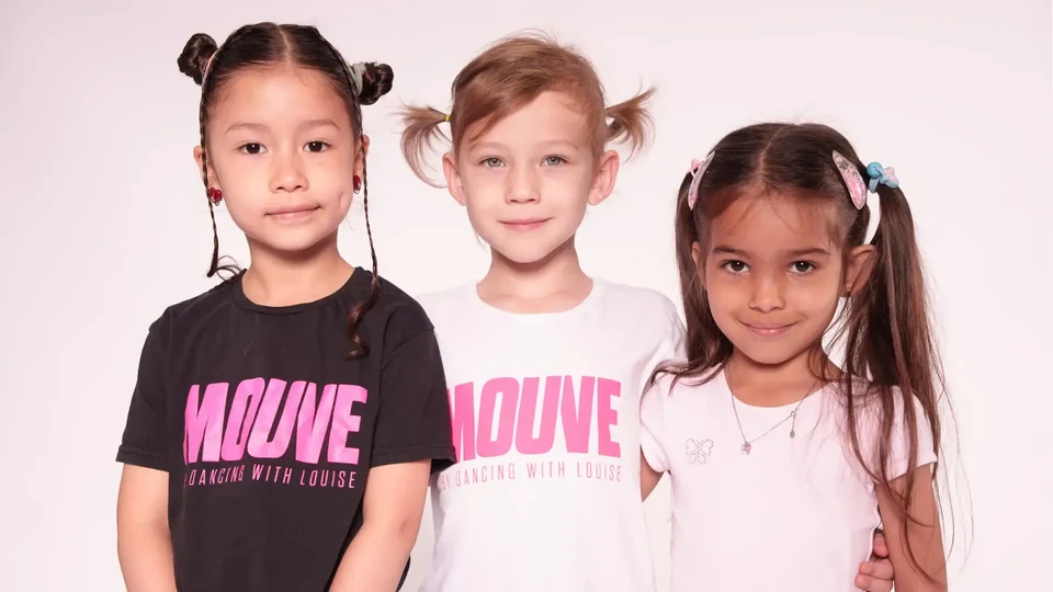 Three children wearing dance t-shirts posing together