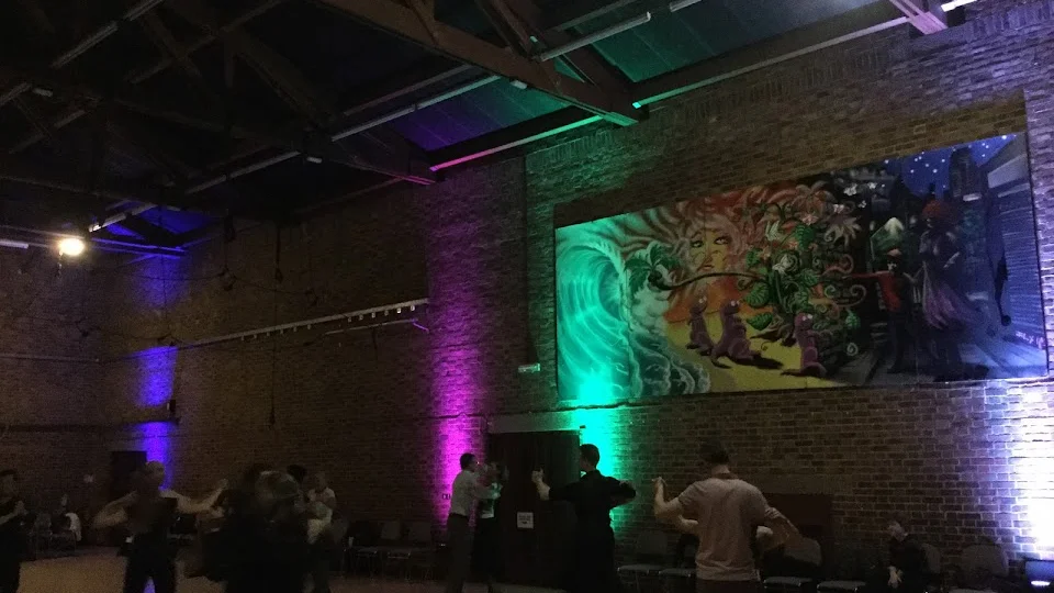 Dance class in a spacious hall with colorful lights