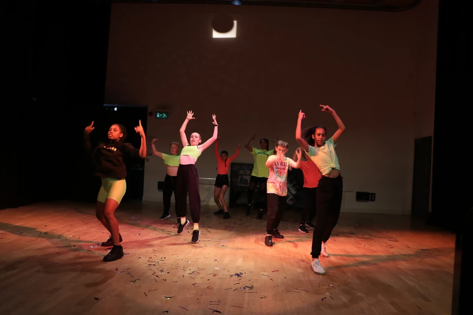Group of dancers performing in a studio setting