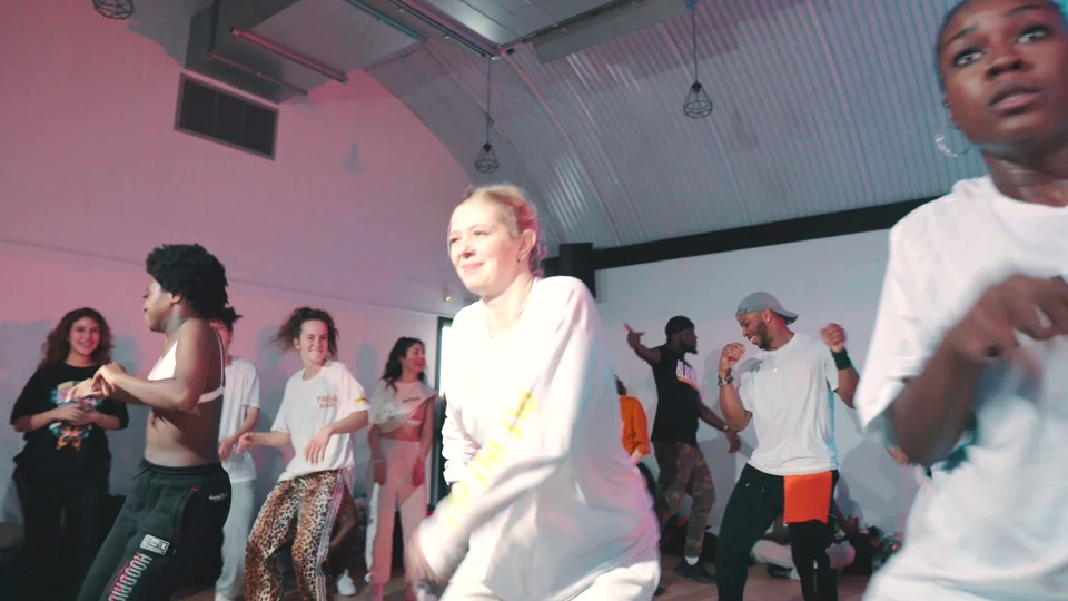 Group of dancers in a studio performing together
