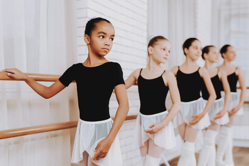 Young ballet dancers practicing at the barre