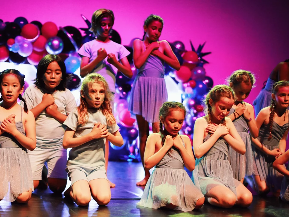 Group of children performing on stage