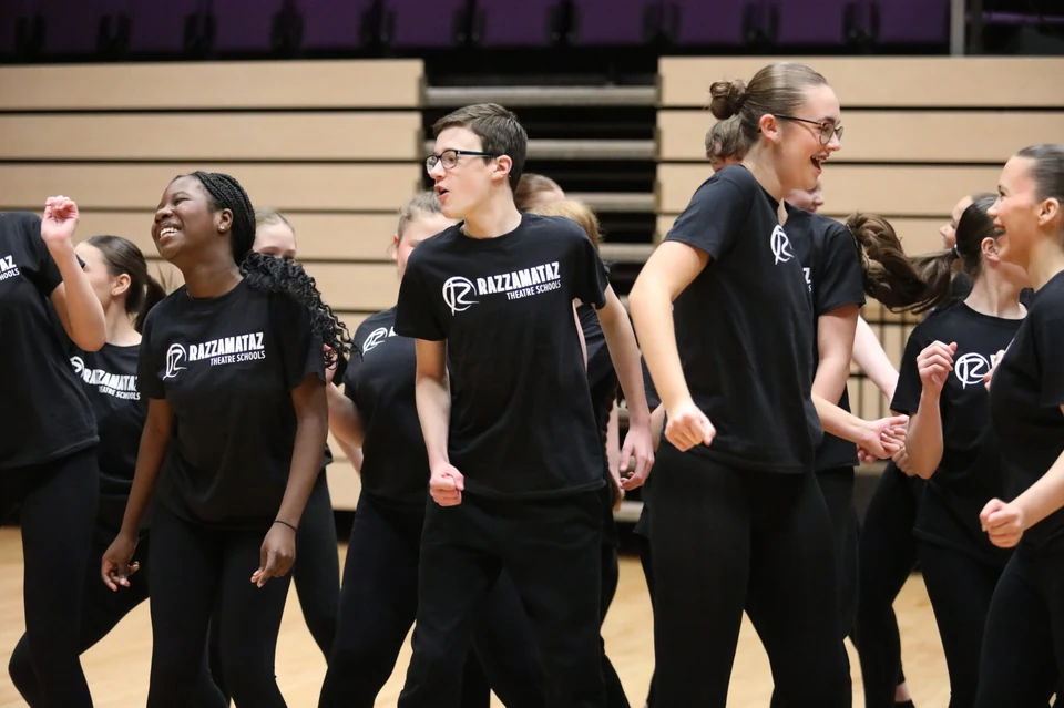 Group of dancers performing in black attire