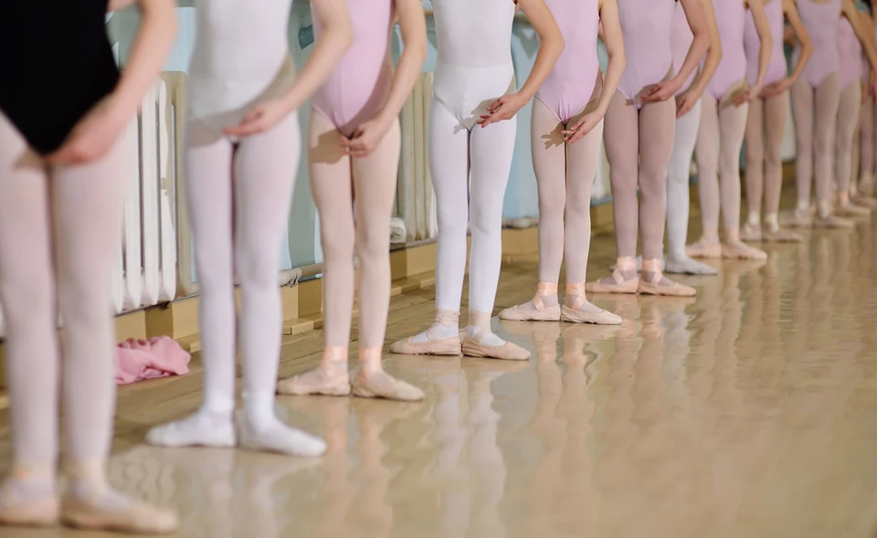 Line of ballet dancers in practice attire