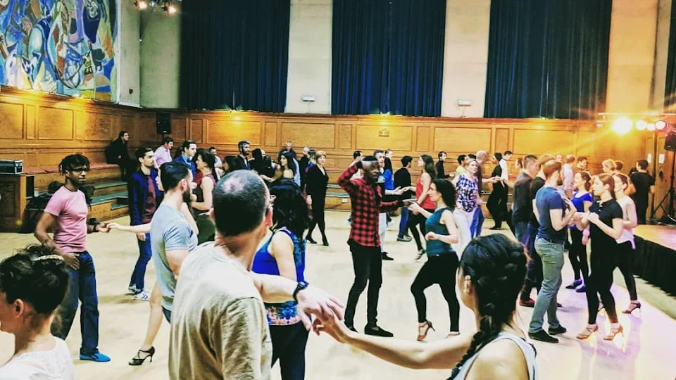 Group of people dancing in a hall