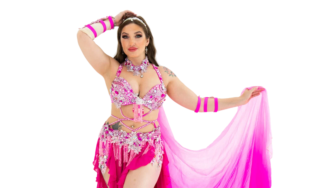 Belly dancer in pink costume with veil