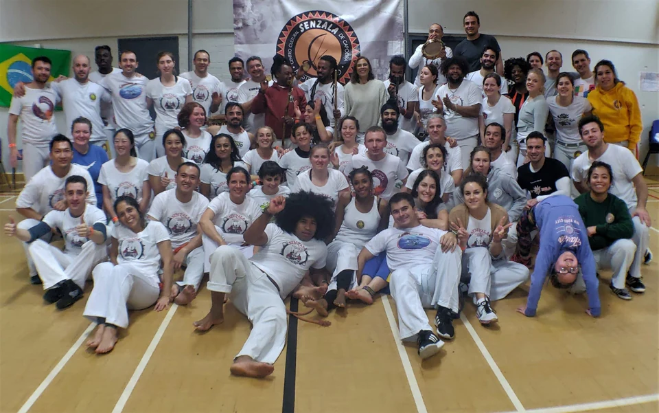 Group of people in Capoeira attire posing together