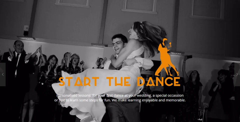 Couple dancing at an event with audience clapping