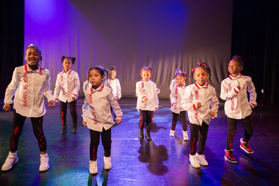 Group of young dancers performing on stage