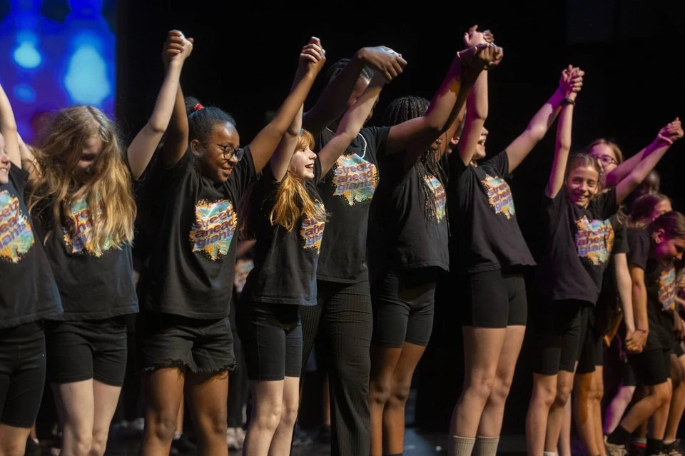 Group of dancers celebrating on stage