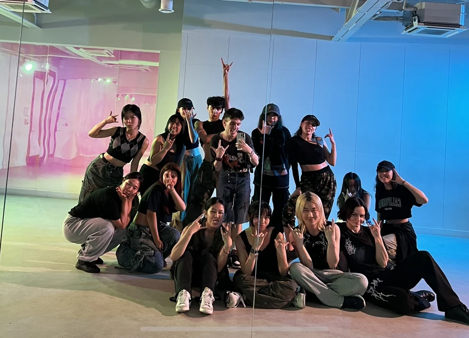 Group of dancers posing in a studio setting