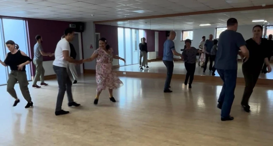 Group of people dancing in a studio